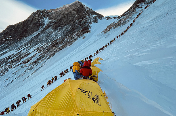A line of people waiting to climb the highest point on our planet - Mount Everest