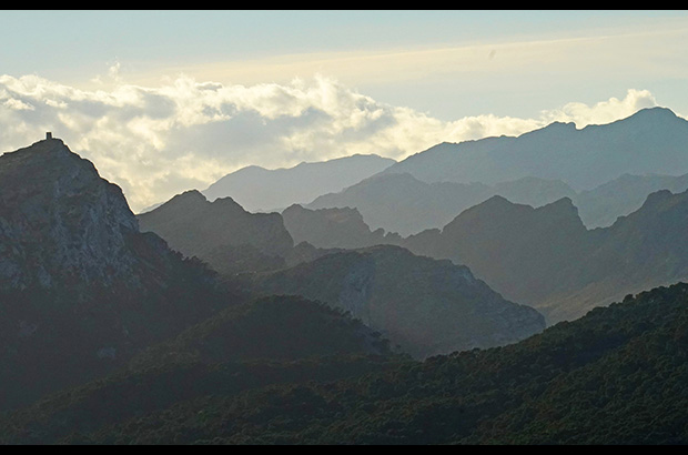 Panorama of the Sierra Tramontana mountain system, Mallorca. On the left on the rock there is a 16th century watchtower, a reminder of the "times of the pirates"